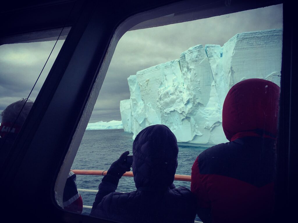 Sailing past an iceberg in Antarctica